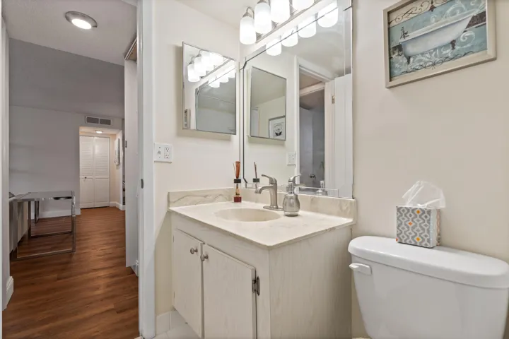 Guest bathroom with view of storage closet as well as a portion of the laundry area.