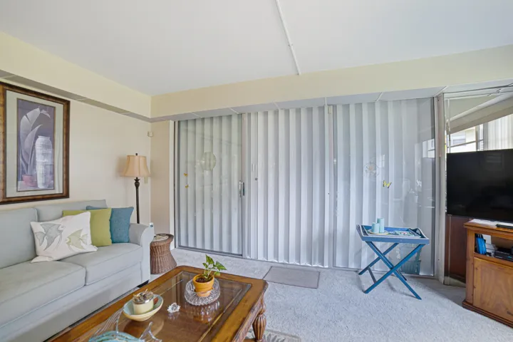 LIVING ROOM/PATIO ENCLOSURE W/ACCORDIAN SHUTTERS