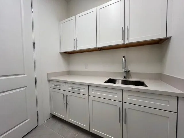 LAUNDRY SINK AND UPPER CABINETS