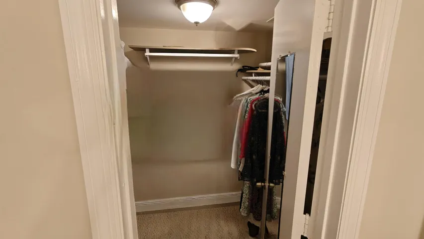 Primary bedroom walk-in closet