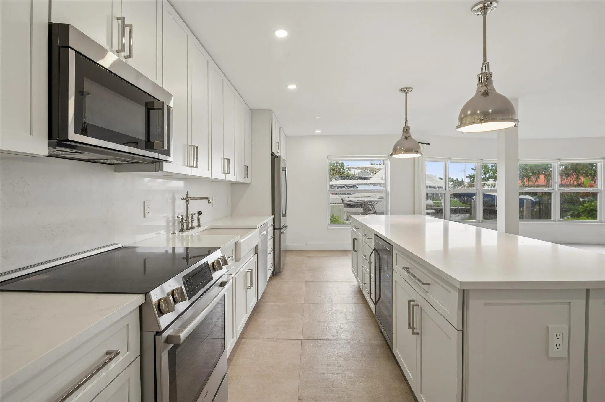 Modern, fully renovated kitchen with custom cabinetry, stainless steel Bosch appliances, and oversized island.