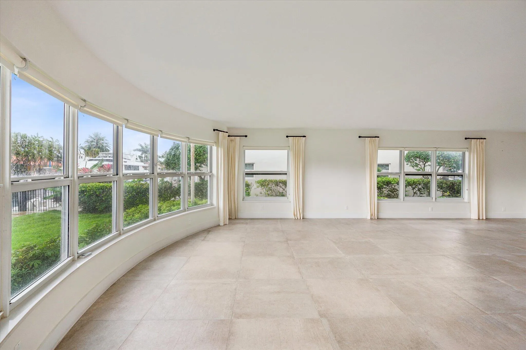 Bright CORNER exposure featuring complete IMPACT glass windows that flood the space with natural light while offering security and peace of mind.