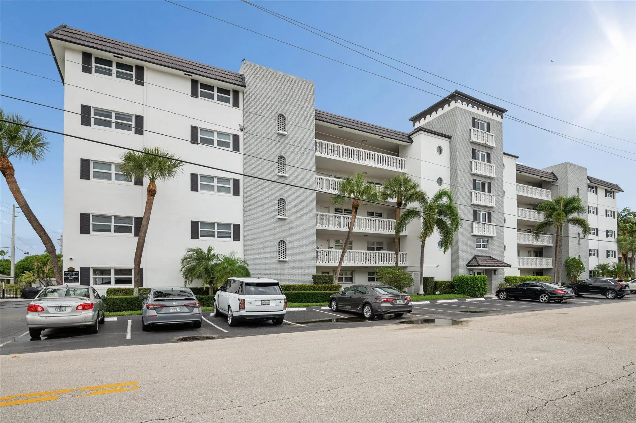 Well-maintained waterfront building with classic coastal architecture and tropical landscaping.