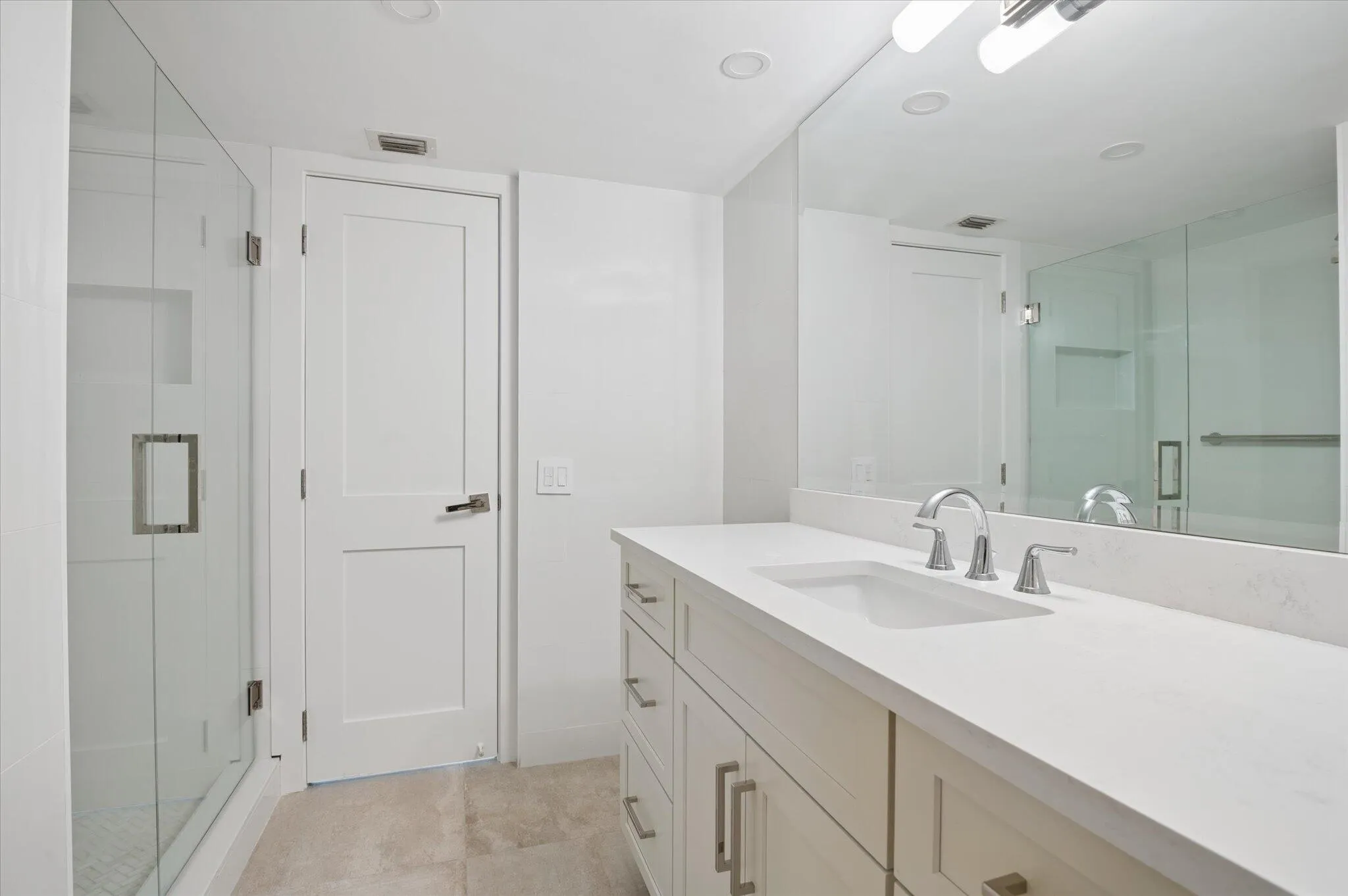 Full bath with glass-enclosed shower and clean, modern finishes.