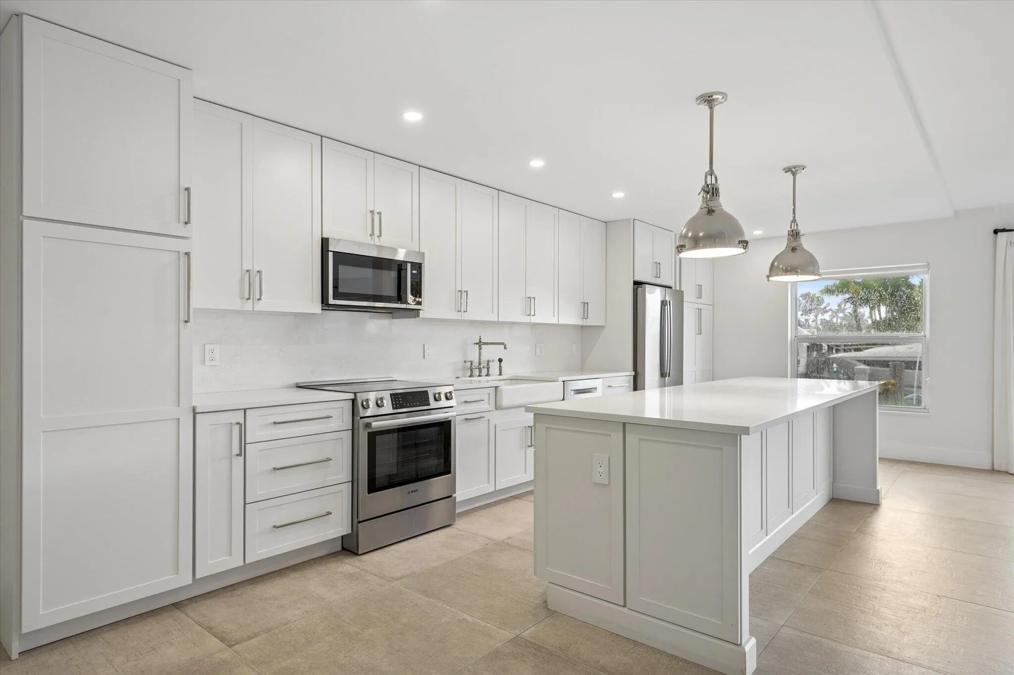 Custom-built kitchen with quartz countertops, shaker cabinetry, and a spacious center island with bar seating—designed for both everyday living and effortless entertaining.