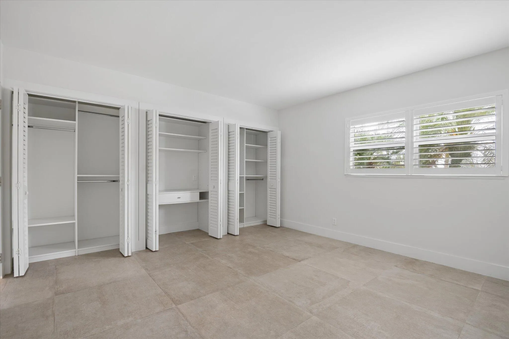 Spacious Guestbedroom with multiple custom closets, offering excellent storage and flexible layout options.