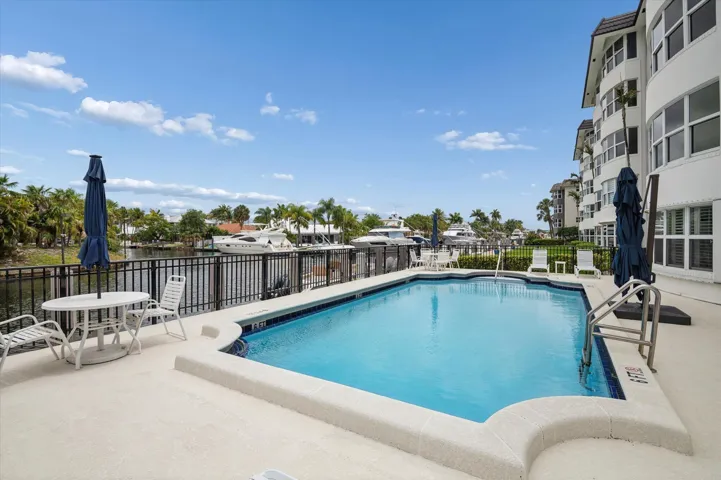 Waterfront pool area overlooking the canal—perfect for relaxing or entertaining.