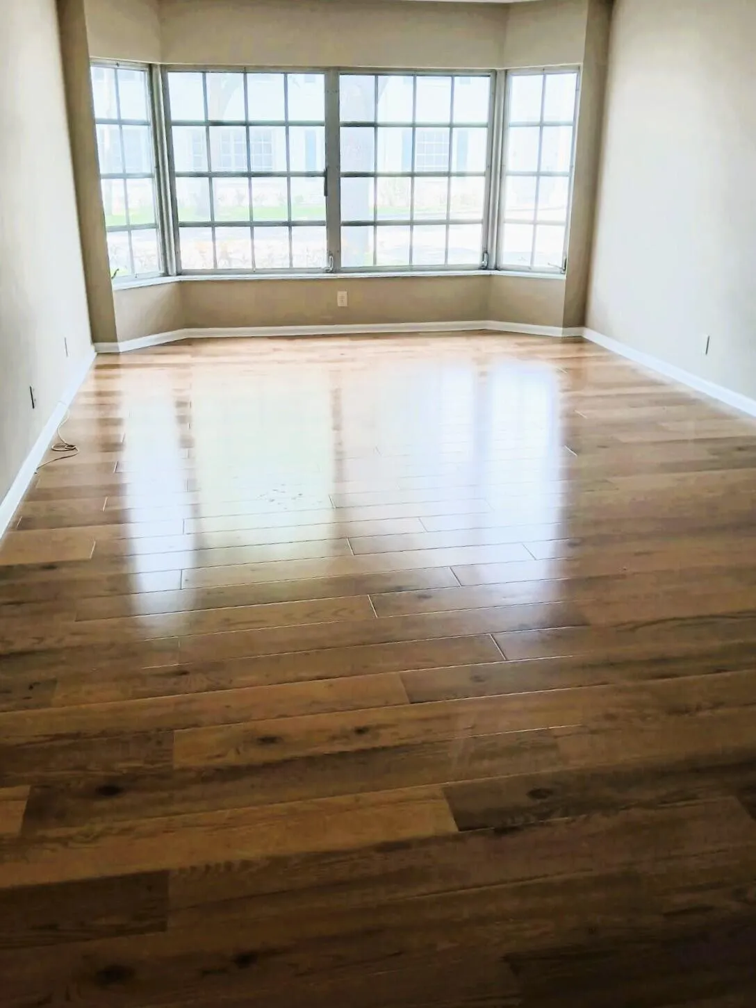 liviing room with large bay window (as you enter condo)