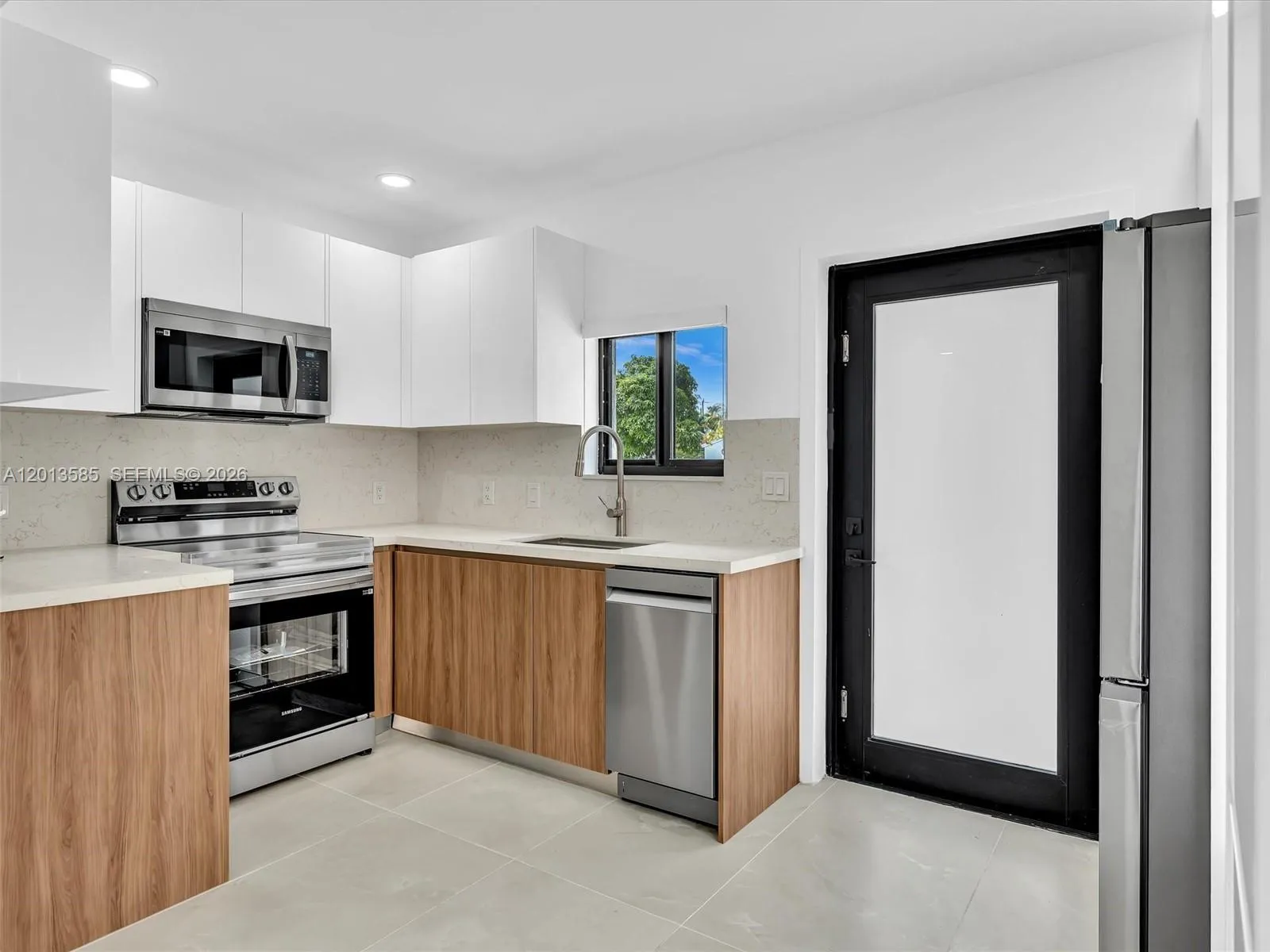 European-style kitchen with quartz counters, stainless steel appliances.