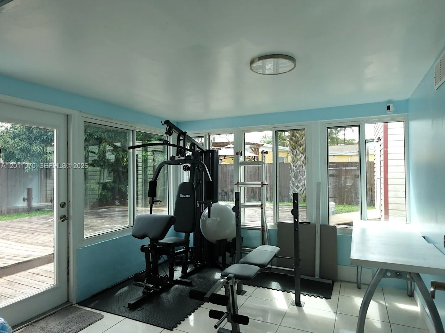Versatile Florida room perfect for relaxation, entertaining, or a home gym