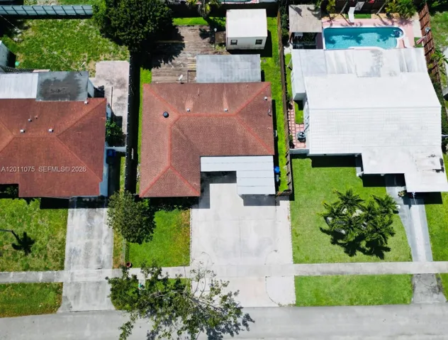 Aerial view showcasing full lot, driveway, and backyard space