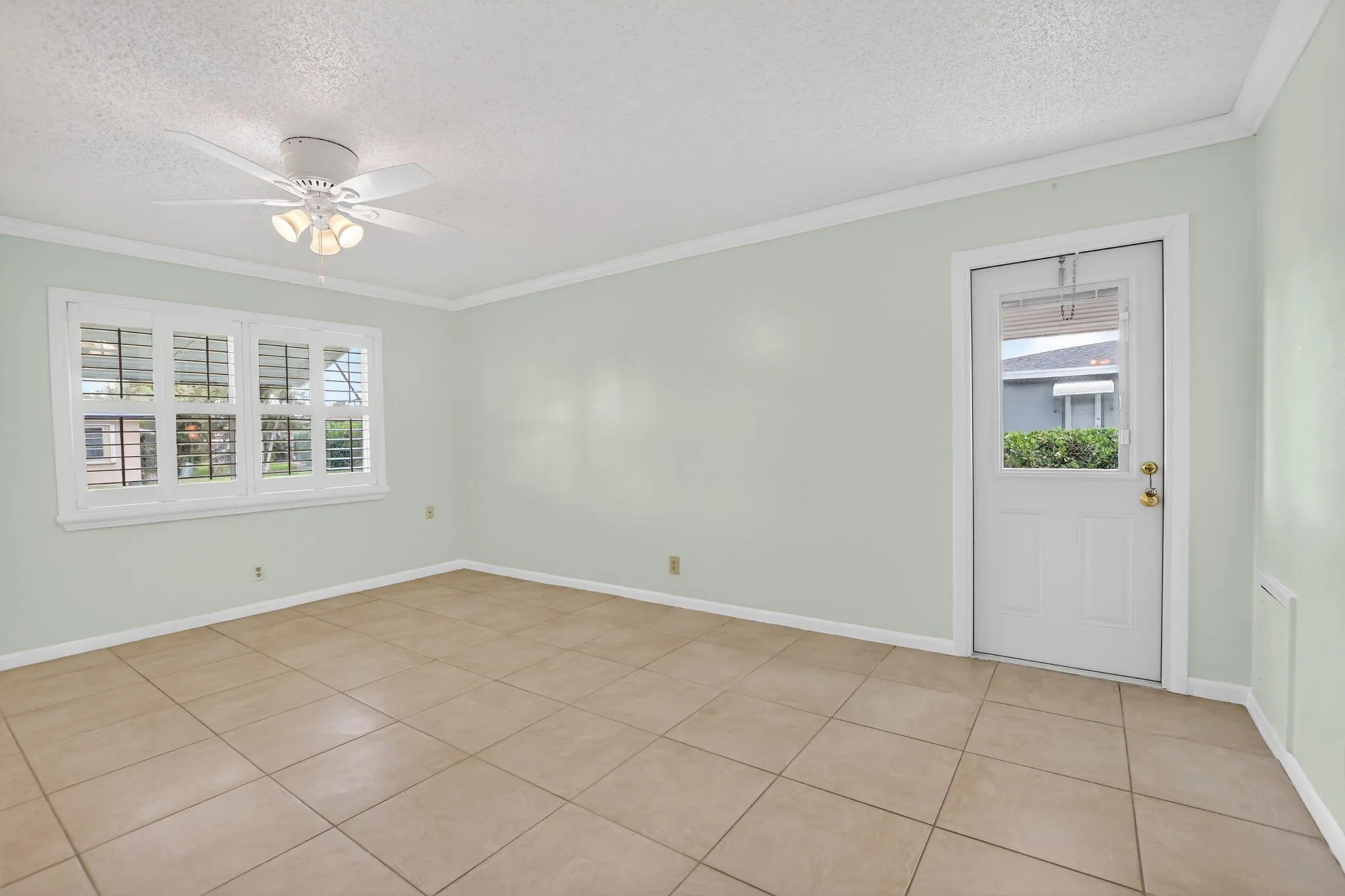 Large Primary bedroom -plantation shutters + tile floors throughout
