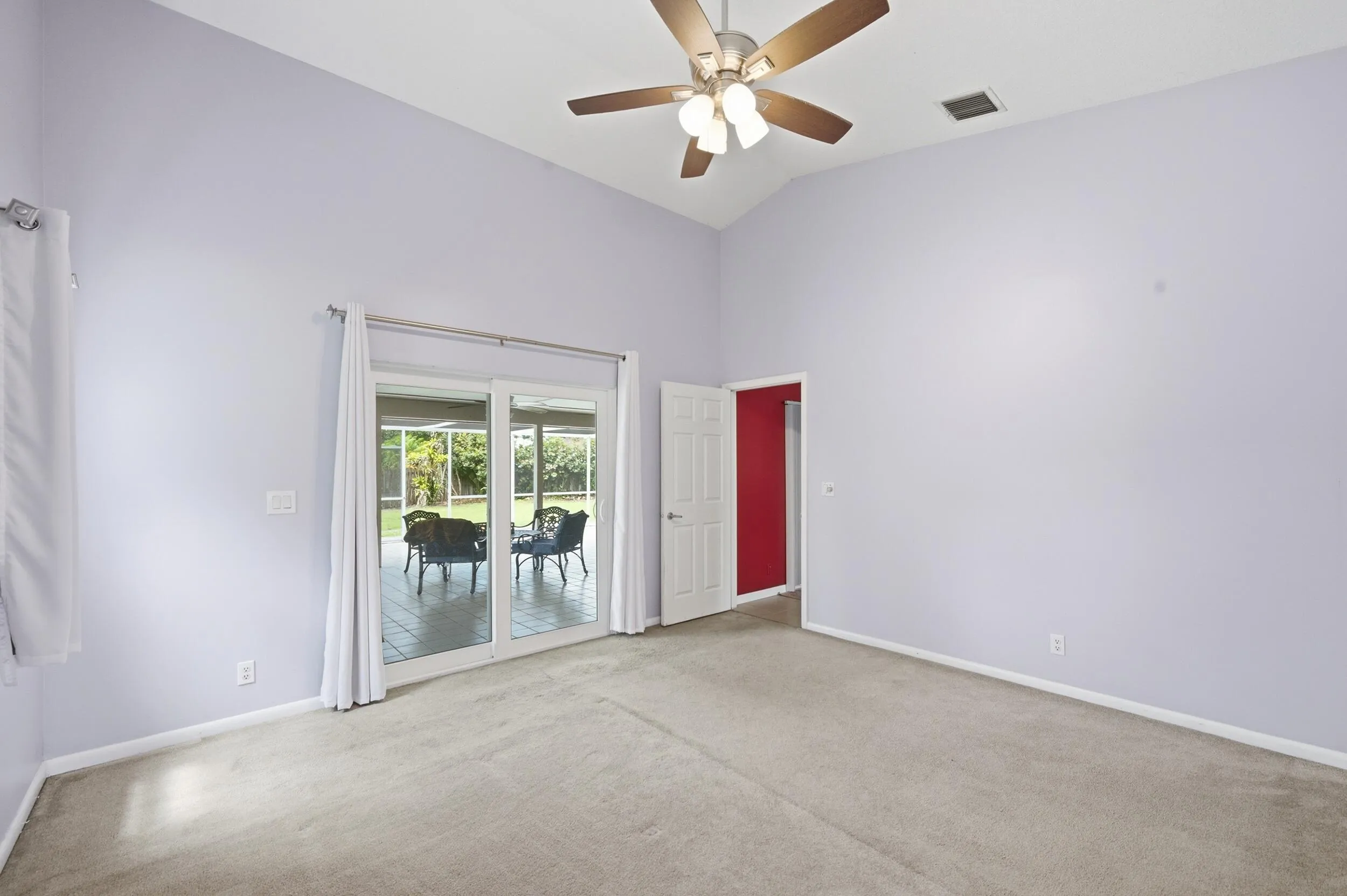 Primary bedroom with patio access.