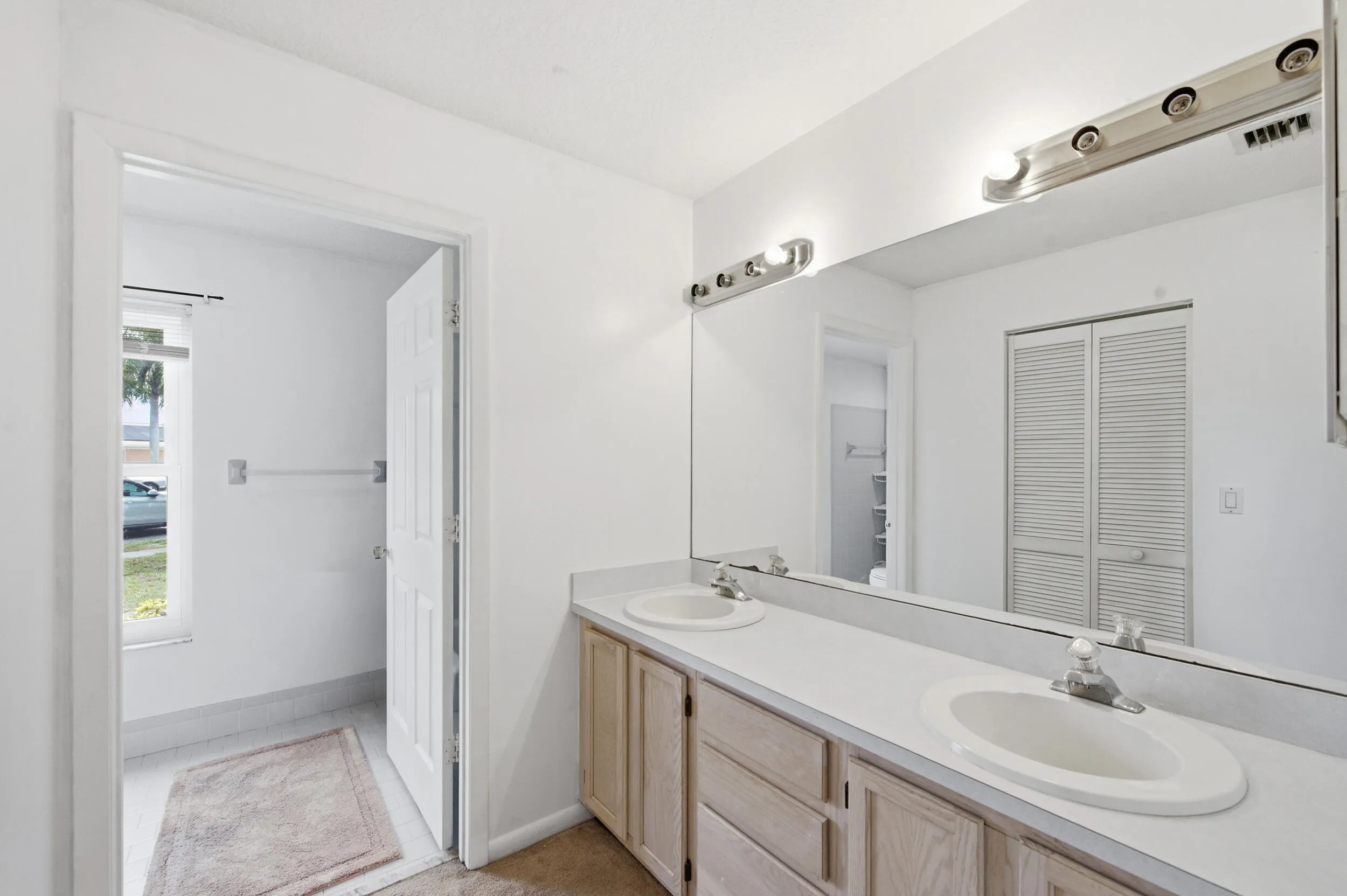 Primary bathroom with dual sink vanity.