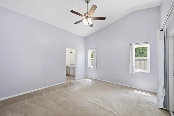 Primary bedroom with vaulted ceilings.