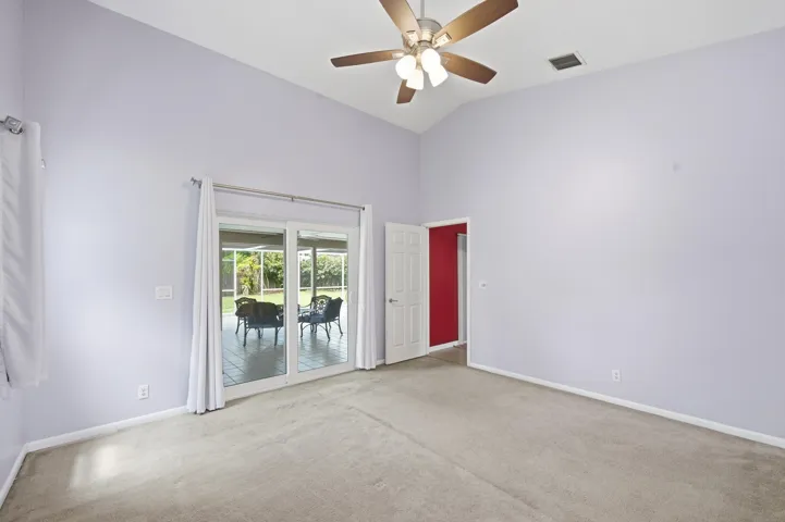 Primary bedroom with patio access.
