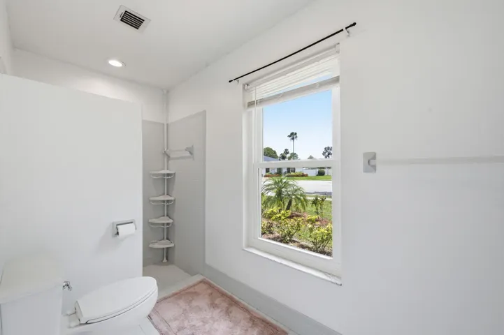 Walk-in shower on one side.