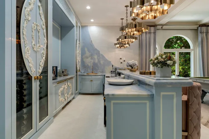 Elegant inside bar with built in wine cabinets hidden flat screen tv and built in pop up wine cruvenet
