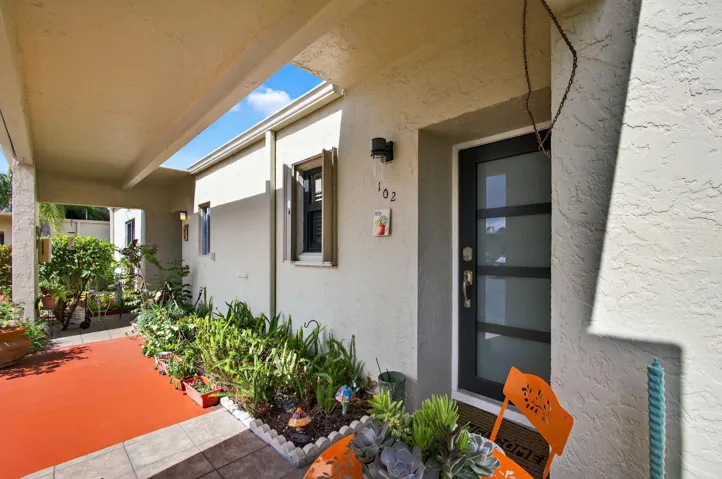 Accent door & beautiful landscaping
