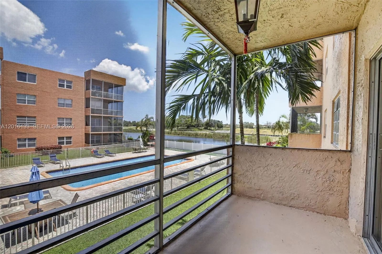 The large screened balcony creates a true indoor-outdoor space, perfect for morning coffee, relaxing evenings, and enjoying the Florida lifestyle.