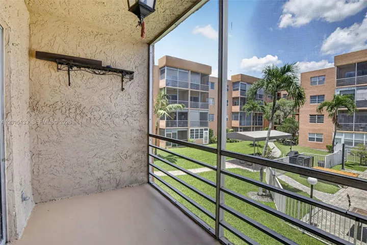 The large screened balcony creates a true indoor-outdoor space, perfect for morning coffee, relaxing evenings, and enjoying the Florida lifestyle.