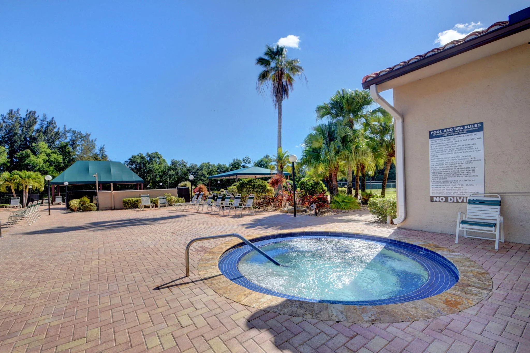 Community spa area adjacent to pool with surrounding deck.”