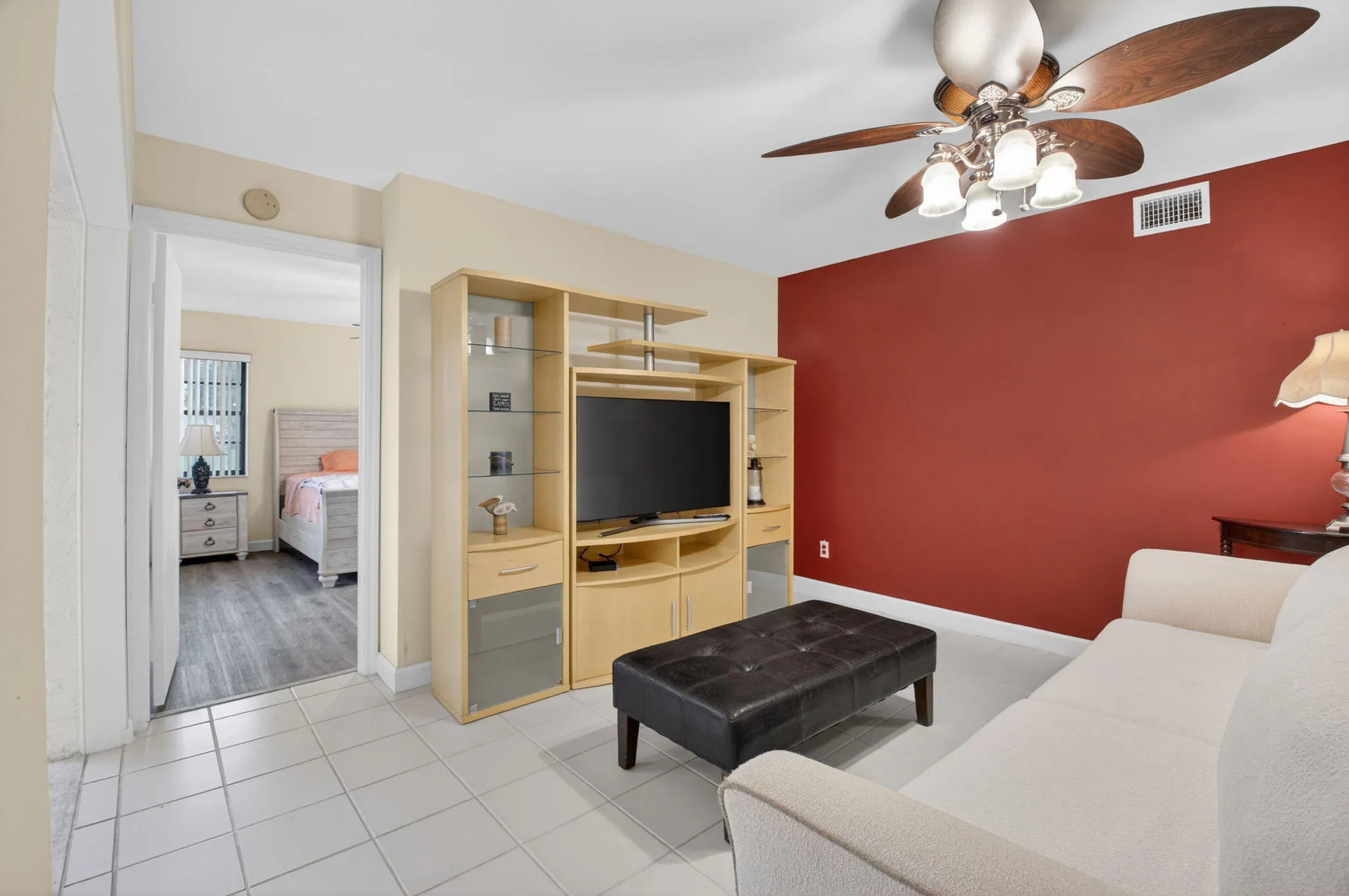 The primary bedroom is right outside th living room and looks onto lots of green space.