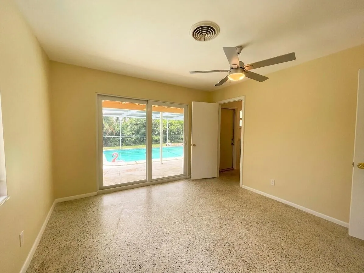 Master Suite with pool view and impact glass sliders to pool deck.