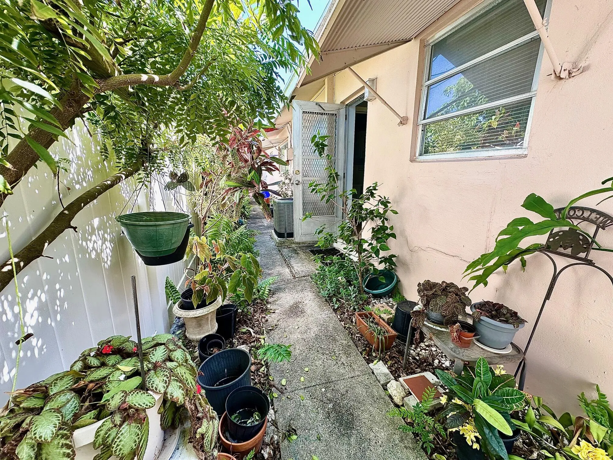 Side door leads to a little tropical retreat!