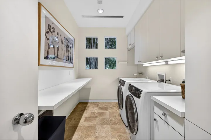 Ample folding and cabinet space in this laundry room