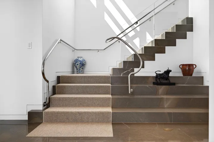 A staircase leading to the primary suite