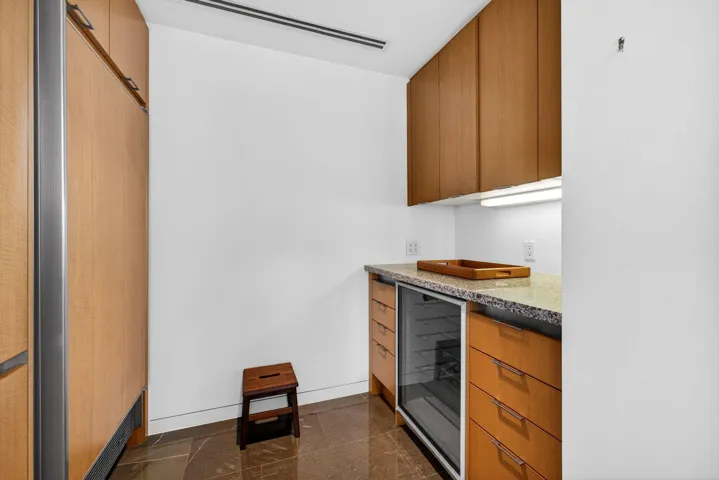 Freezer, wine cooler, and extra storage off the kitchen