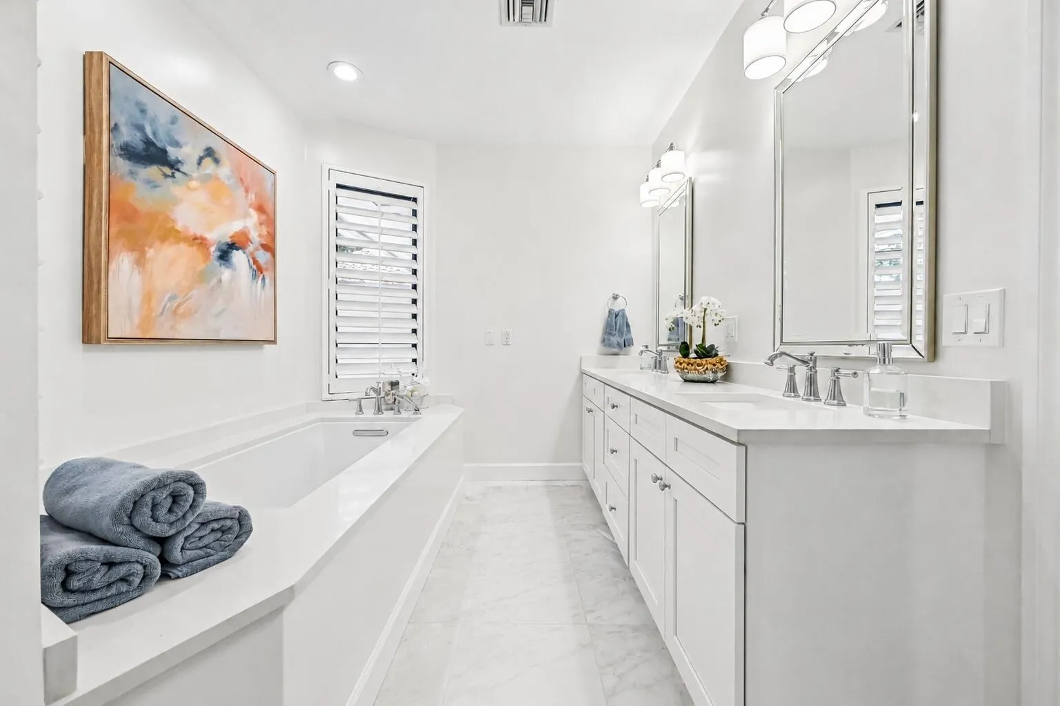 The luxurious primary bathroom features an oversized soaking tub, dual vanities, and a spa-like atmosphere designed for relaxation.