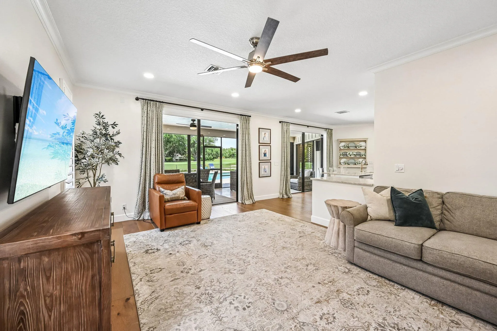 The casual den located off of the kitchen has slider doors to one of the 2 screened in lanais.
