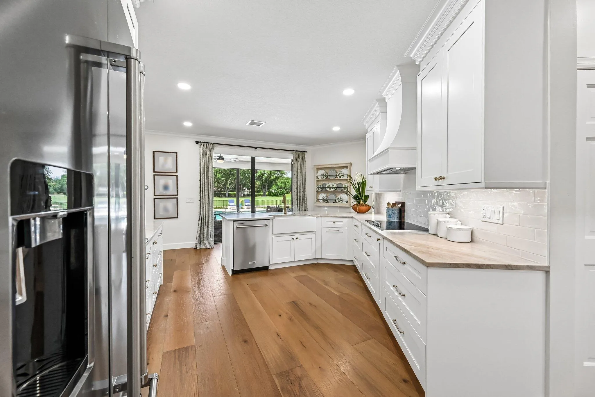 Premium KitchenAid appliances including a French door refrigerator, double oven/microwave, and built-in cooktop.