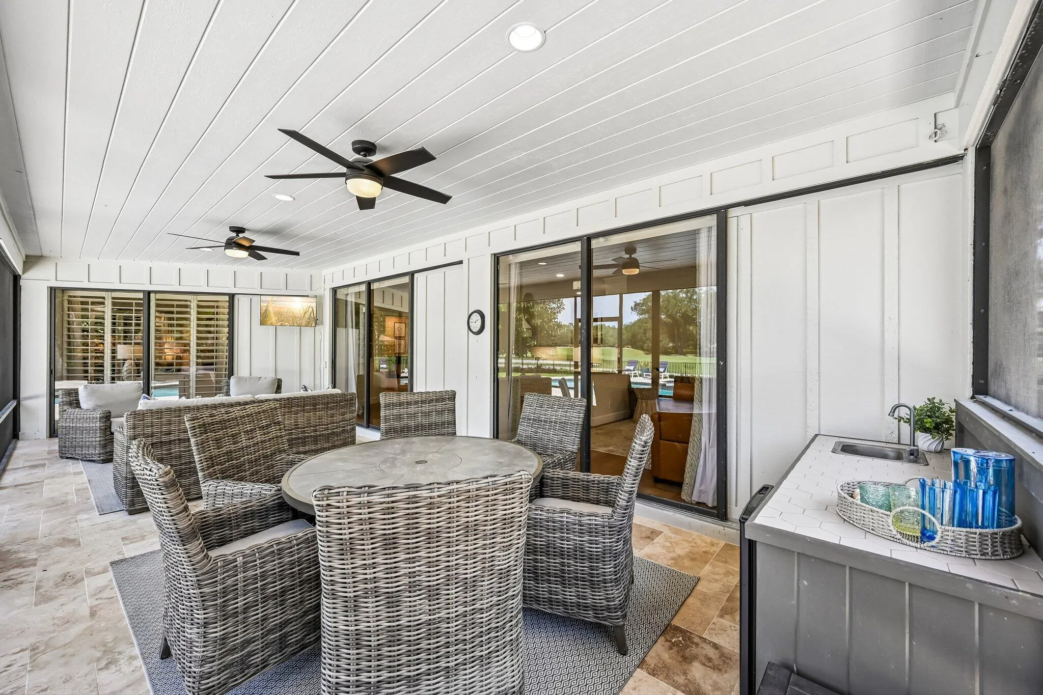 Perfect for entertaining, the lanai features a well-appointed summer kitchen with sink and refrigerator, blending convenience with outdoor living.