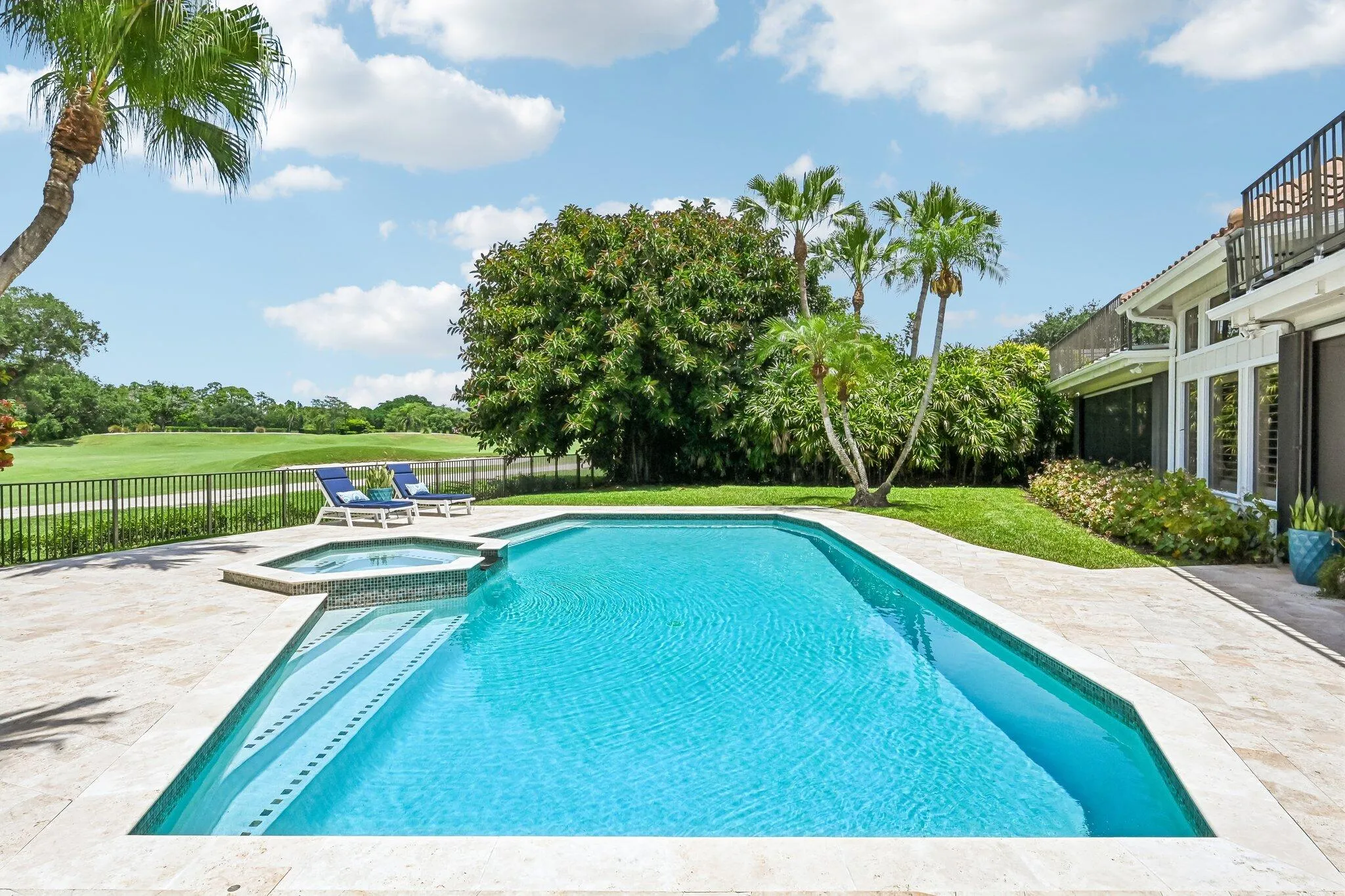 The backyard invites relaxation and recreation with a sparkling pool for refreshing dips and a heated spa for year-round comfort.