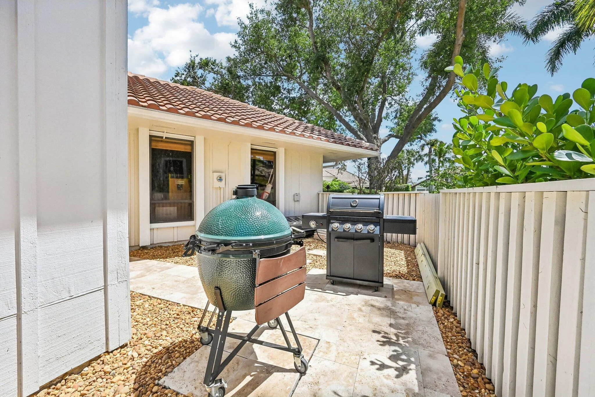 The private grilling area, located on the side of the home, offers easy access to both the pool and kitchen, ideal for effortless outdoor entertaining.