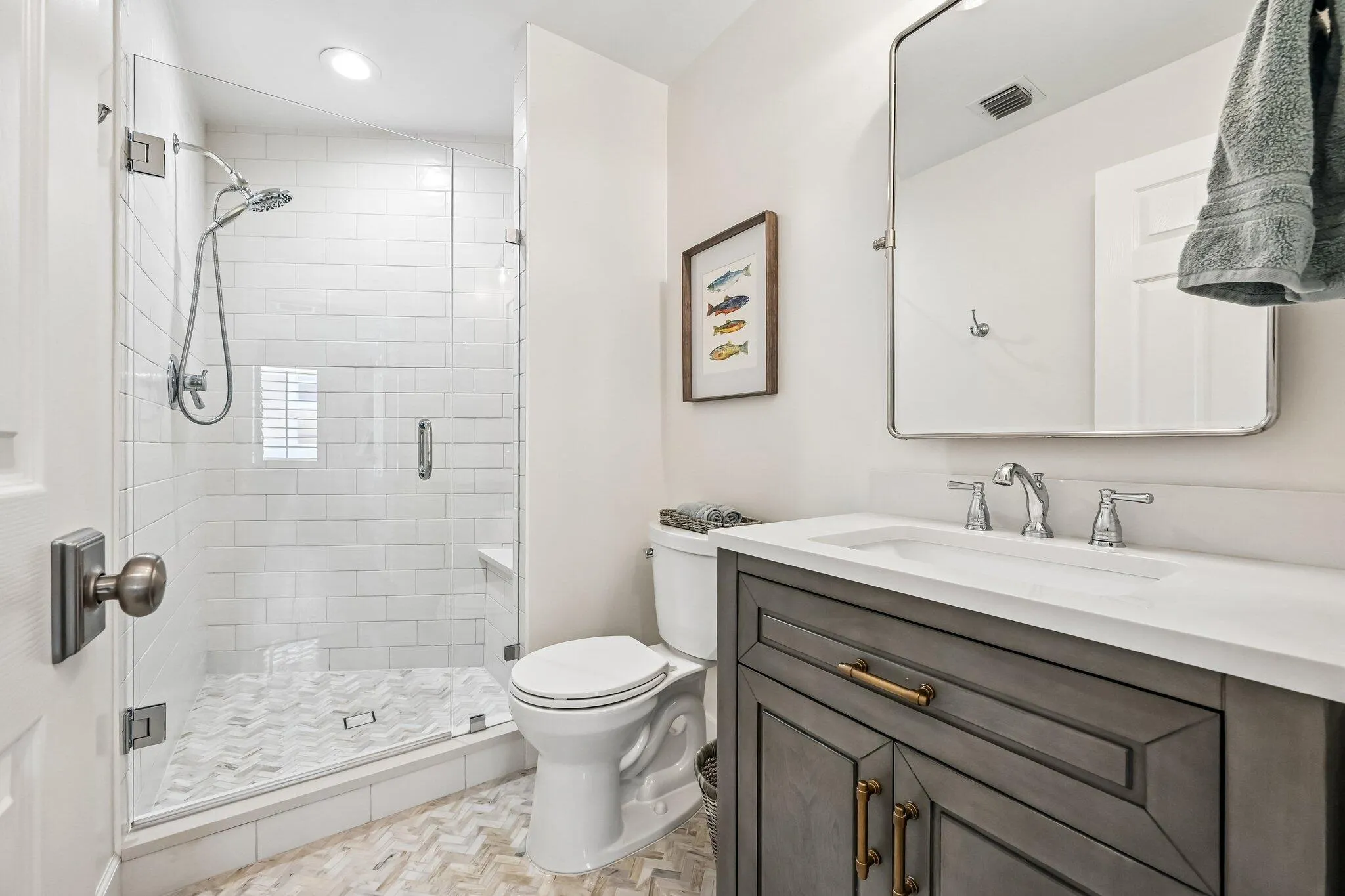 Positioned just off bedroom #3, the secondary bathroom offers a generous walk-in shower complemented by sophisticated, elegant design details.
