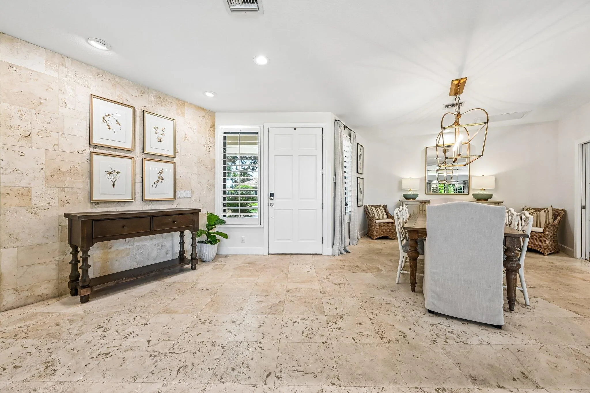 Dramatic Travertine wall and floors welcome guests