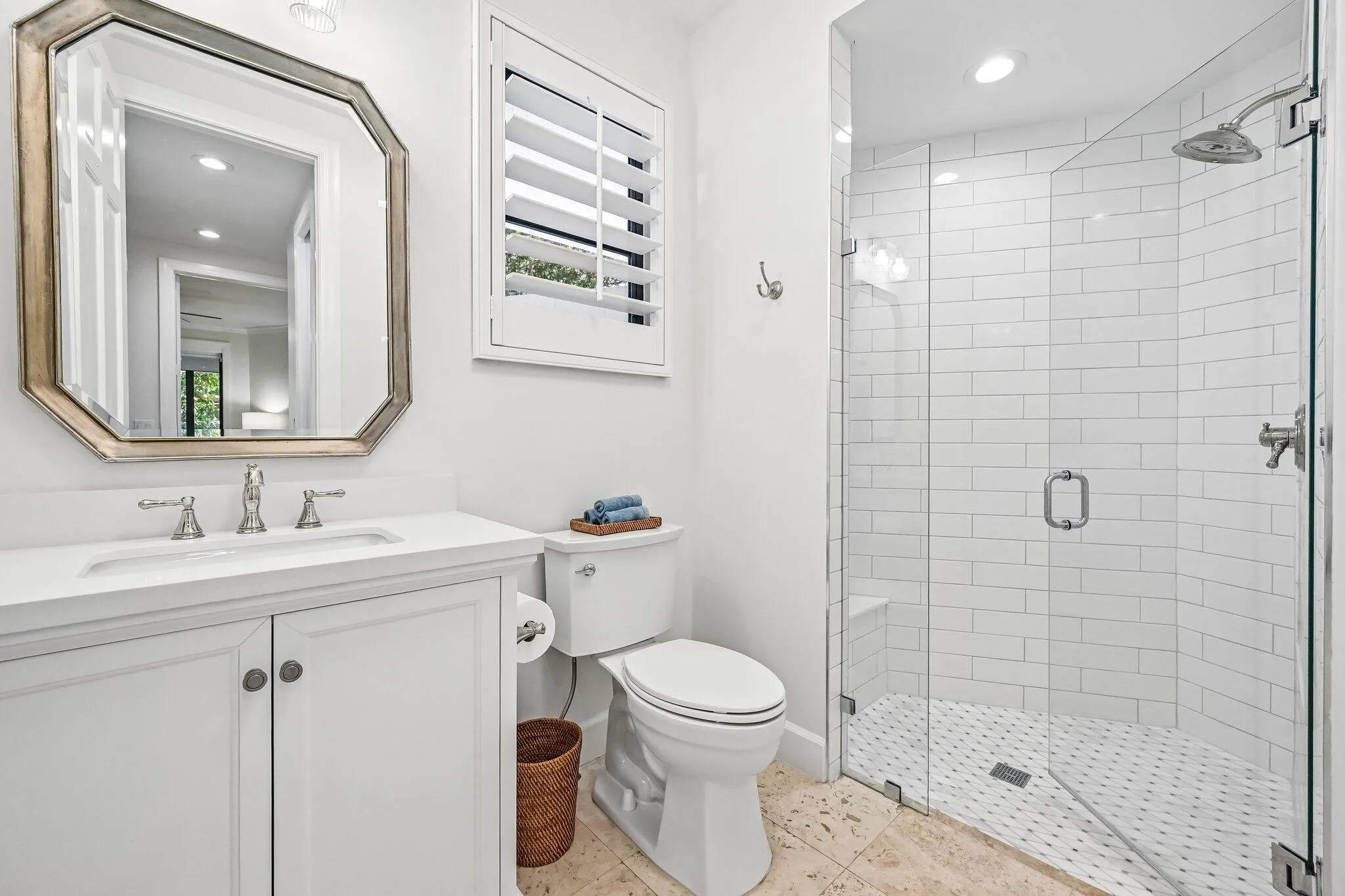 The main-floor full bathroom features a spacious walk-in shower, thoughtfully designed for both comfort and convenience.