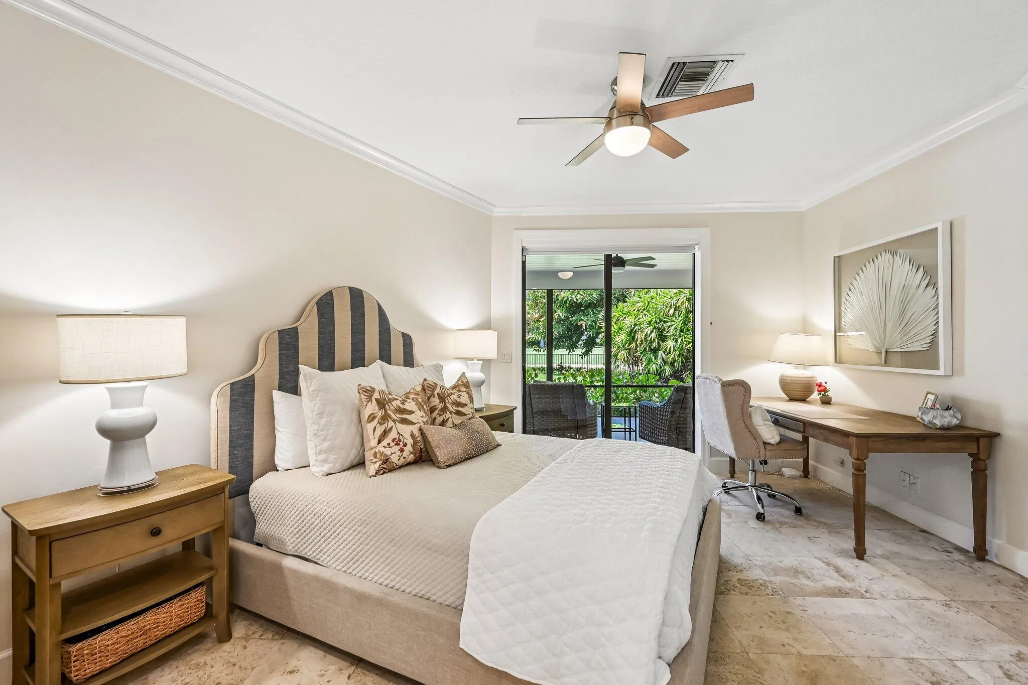 Main-floor bedroom #2 offers private sliding door access to the second screened lanai, where tranquil golf course views create a peaceful retreat.