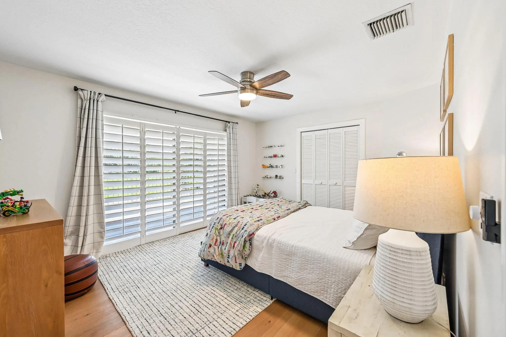Located upstairs, bedroom #3 offers a walk-in closet and sliding doors leading to a large deck showcasing sweeping golf course views.