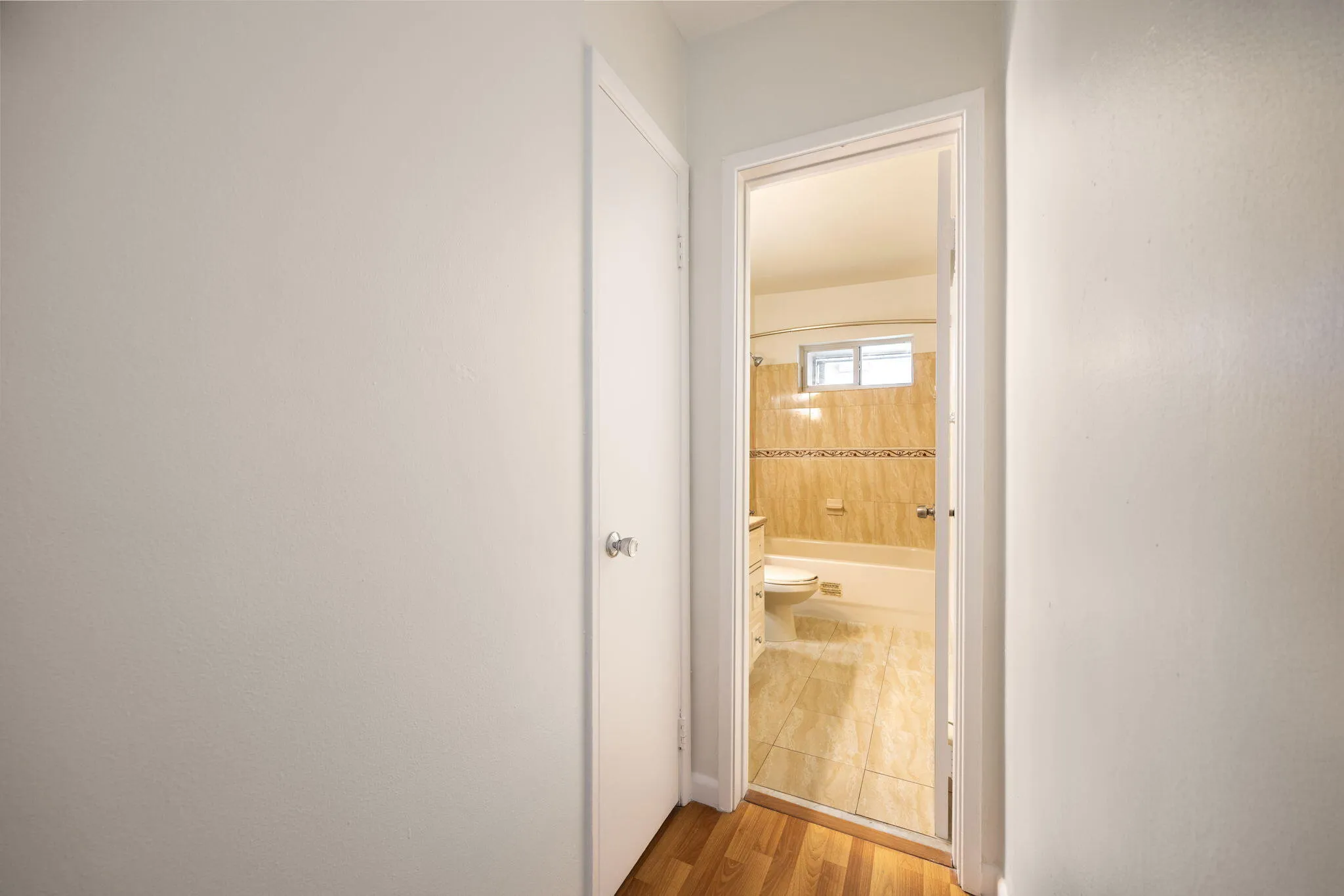 Hallway view to bathroom and linen closet