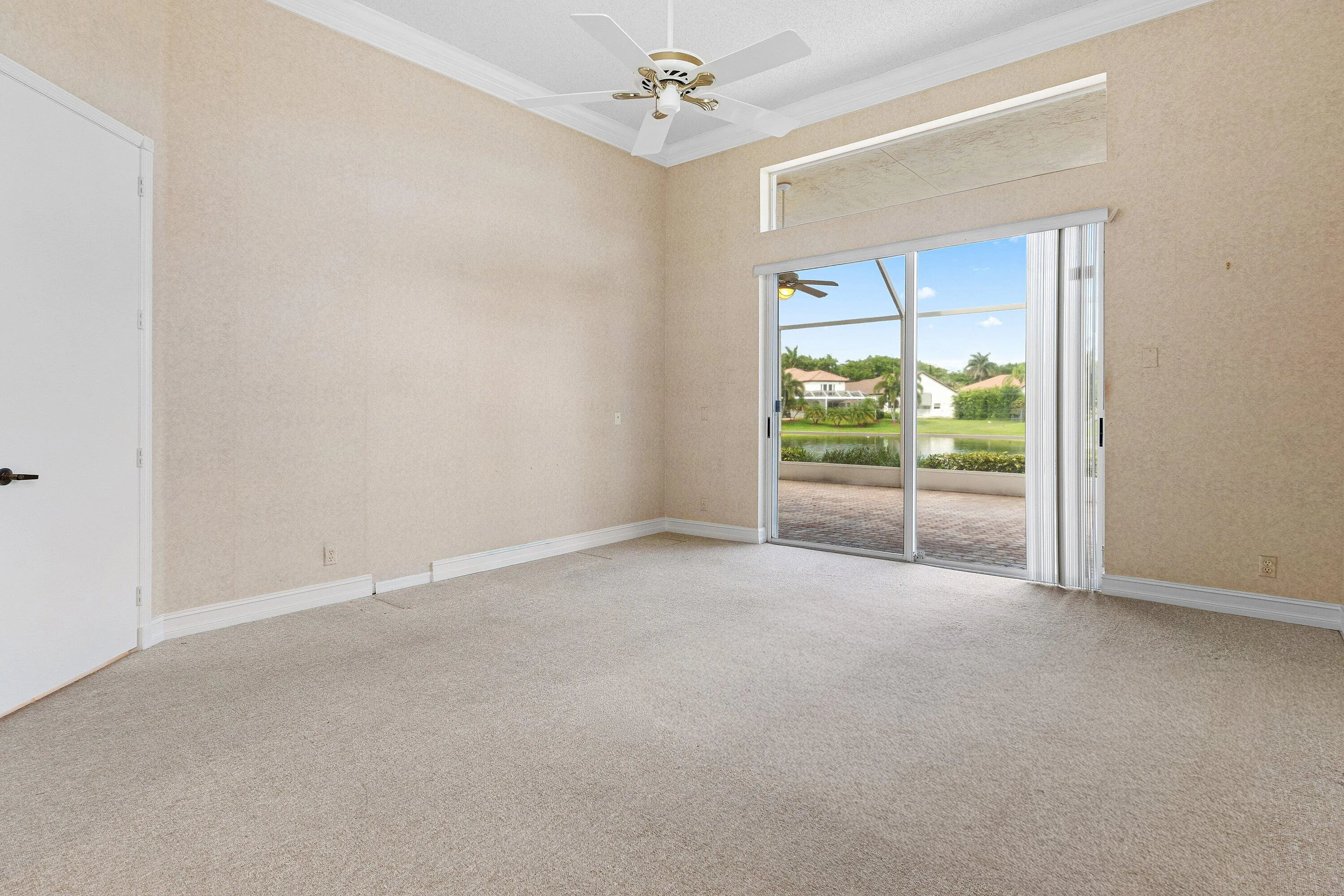 Primary Bedroom with lake views and crown molding