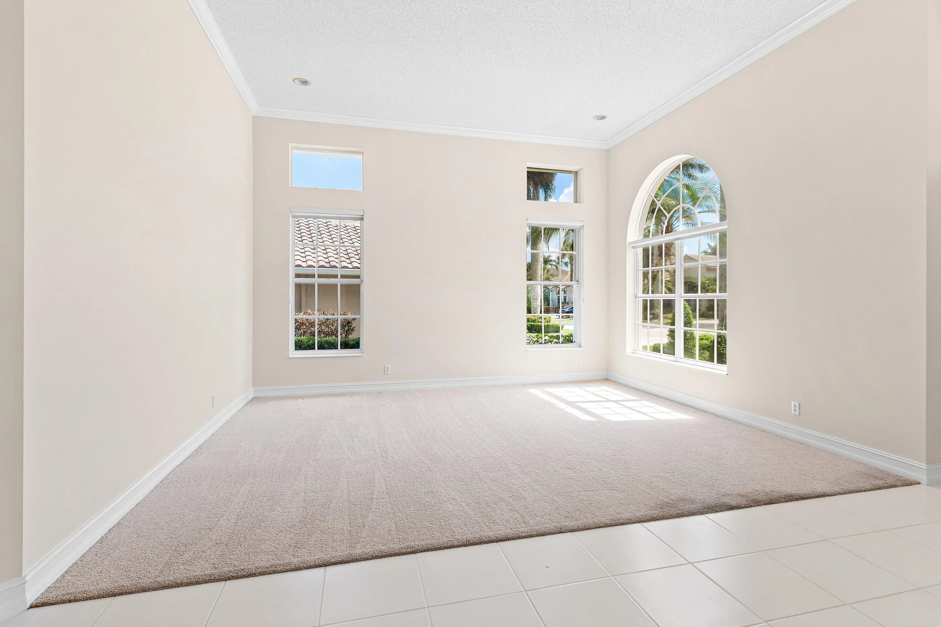 Living Room with volume ceilings and crown molding