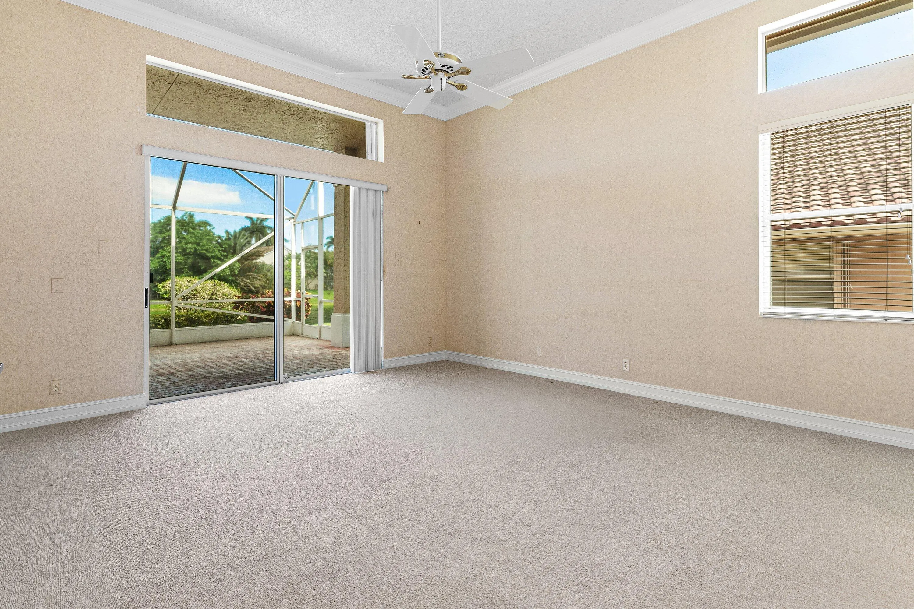 Primary Bedroom with Lake views and sliding glass doors to enclosed screened in patio