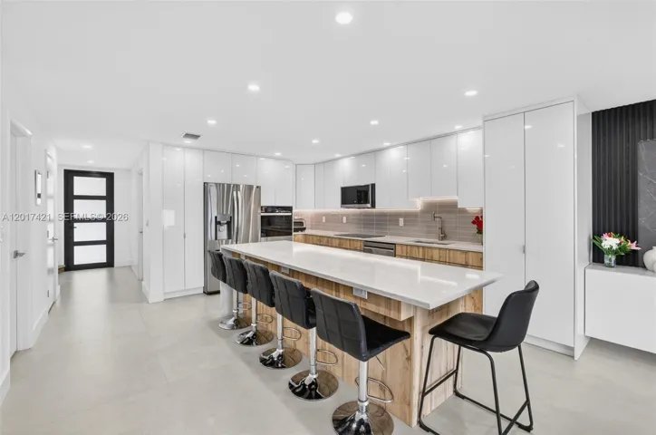 Counter seating for 5 seats (extra one on end makes 6). Beautiful impact front door for more natural light. any high hats in ceiling for kitchen lighting