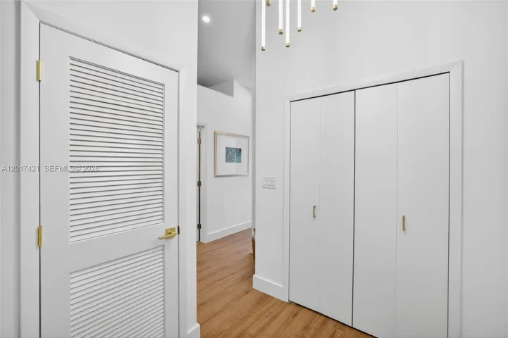 Upstairs landing w/ chandelier / fixture, view to additional bedrooms