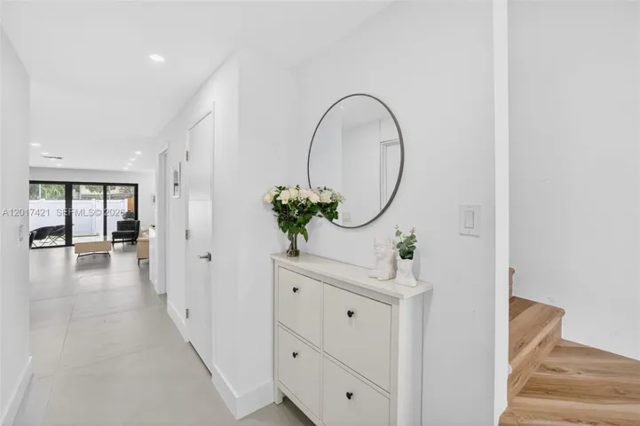 Door to right is a closet for under stairs storage, and the next door is the 1/2 bathroom